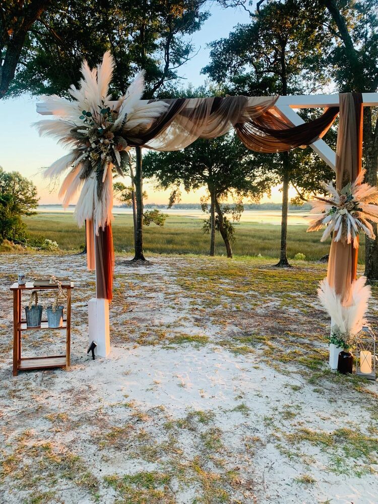 Boho ceremony arch at golden sunset