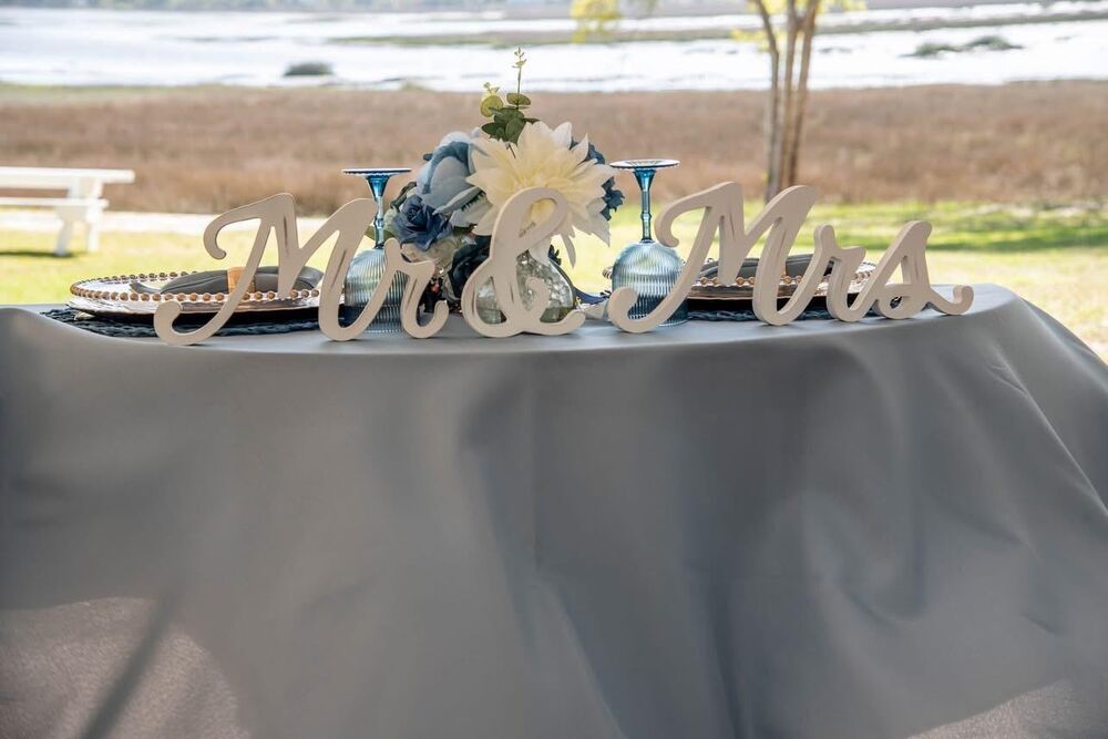 Mr. & Mrs. sweetheart table with blue champagne flutes